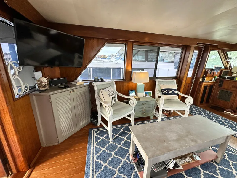 Slide: The Image of Interior of 1978 Hatteras 53 Motor Yacht with cozy seating and nautical decor. - 38