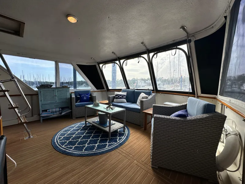 Slide: The Image of 1978 Hatteras 53 Motor Yacht interior with cozy seating and nautical decor. - 42