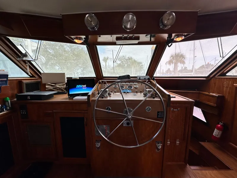 Slide: The Image of 1978 Hatteras 53 Motor Yacht helm with wooden interior and steering wheel. - 47
