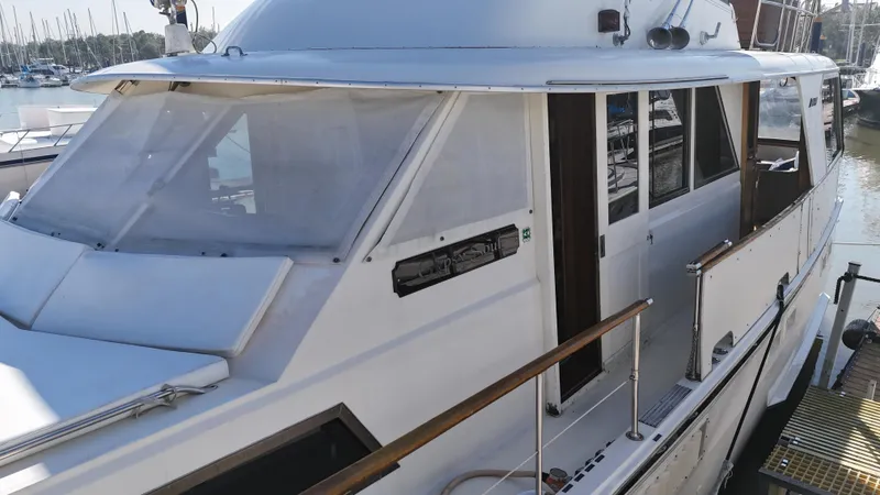 Slide: The Image of 1978 Hatteras 53 Motor Yacht docked at marina, side view. - 5