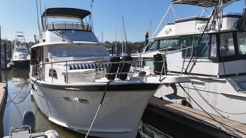 Slide: The Image of 1978 Hatteras 53 Motor Yacht docked at marina under clear blue sky. - 7