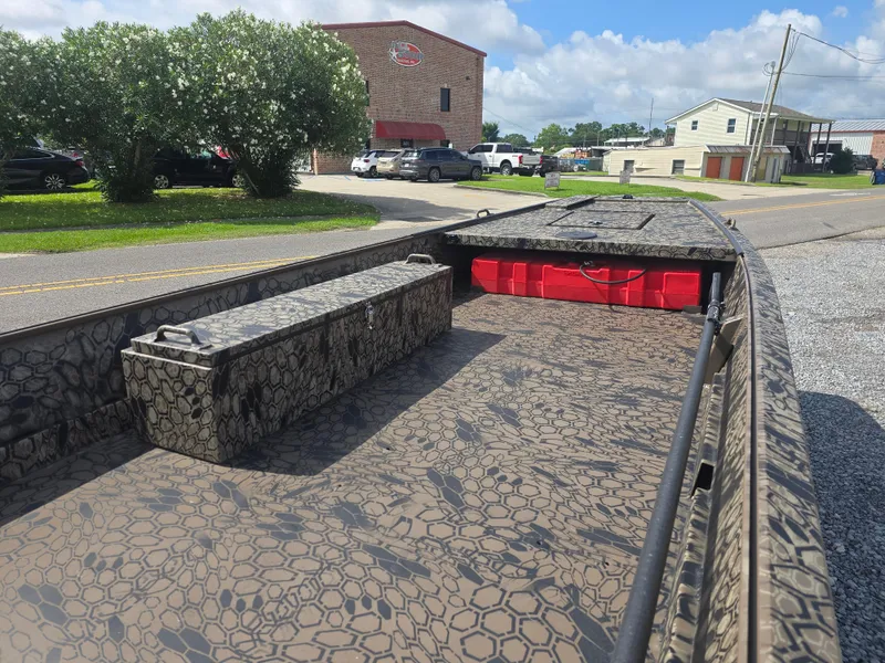 Slide: The Image of 2025 Pro-Drive 1848 SBX boat with camouflage pattern, parked outdoors on a sunny day. - 10