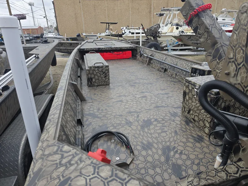 Slide: The Image of 2025 Pro-Drive 1848 SBX boat with camouflage interior, docked outdoors. - 7