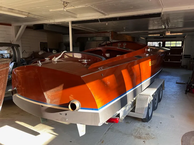 Slide: The Image of Classic 2000 Paul Dewhurst Gentleman's Racer boat in garage, showcasing sleek wooden design. - 6