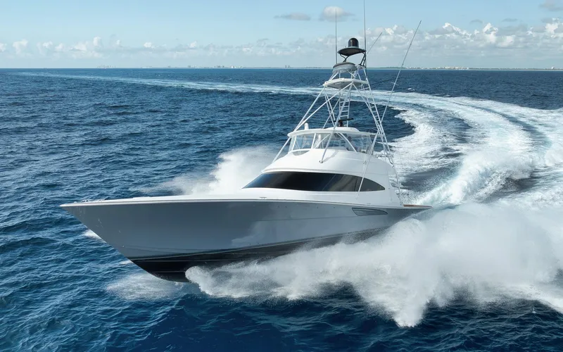 Slide: The Image of 2024 Viking 72 Convertible yacht cruising swiftly on open ocean waters. - 1