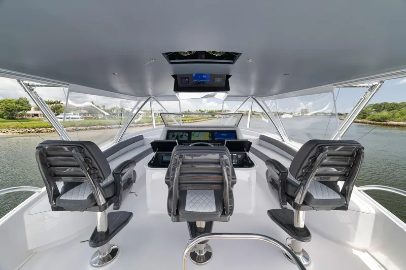 Slide: The Image of 2024 Viking 72 Convertible yacht helm with modern controls and panoramic view. - 11