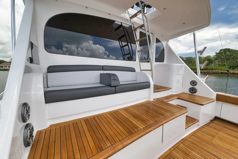Slide: The Image of Luxurious seating area on 2024 Viking 72 Convertible yacht with teak flooring and modern design. - 19