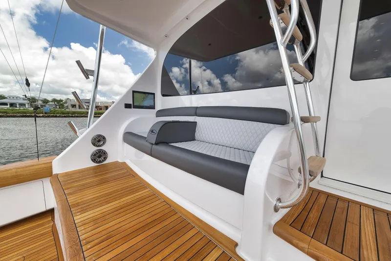 Slide: The Image of 2024 Viking 72 Convertible yacht with sleek seating and wooden deck. - 20