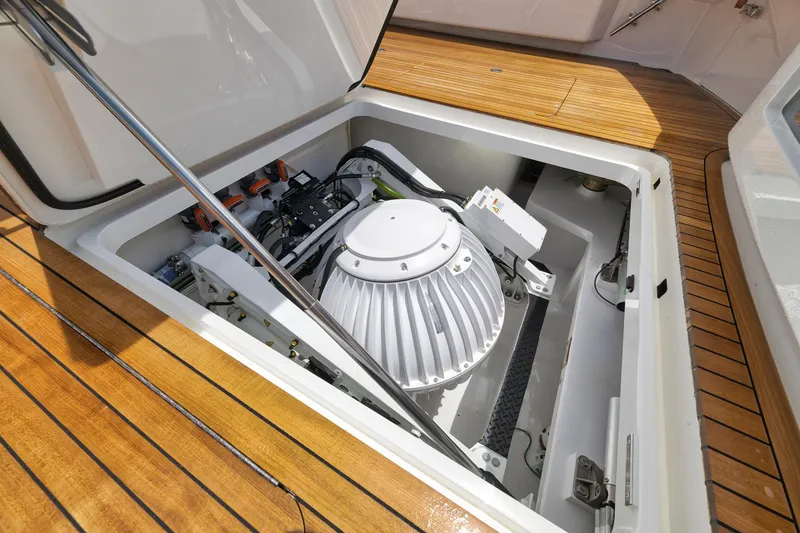 Slide: The Image of Engine compartment of 2024 Viking 72 Convertible yacht with advanced machinery and wooden deck. - 25