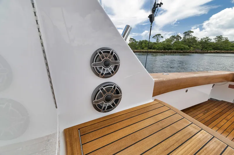 Slide: The Image of 2024 Viking 72 Convertible yacht deck with speakers and wooden finish. - 27