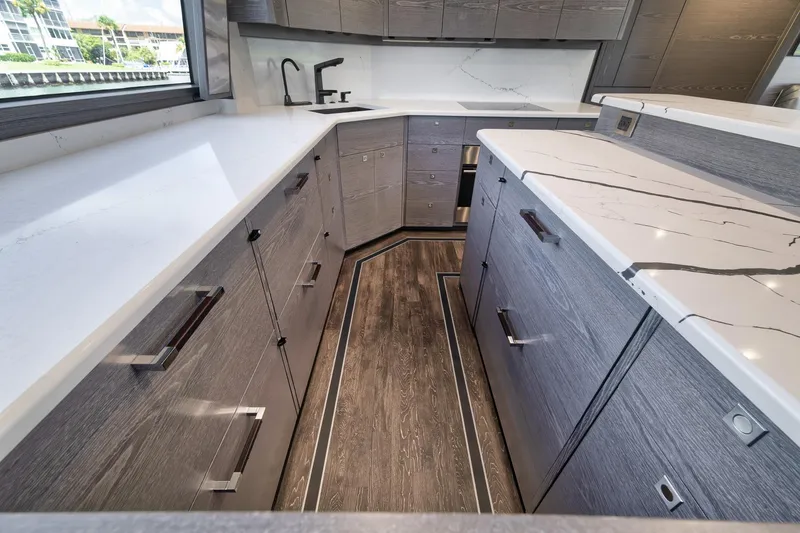 Slide: The Image of Modern kitchen interior of 2024 Viking 72 Convertible yacht with sleek countertops and cabinetry. - 39