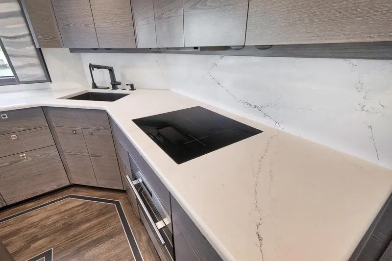 Slide: The Image of Modern kitchen in 2024 Viking 72 Convertible yacht with sleek countertops and appliances. - 40