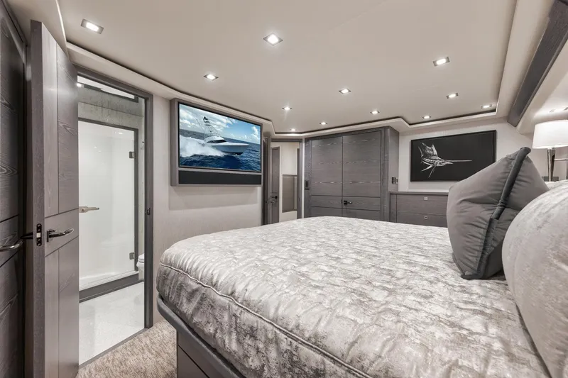 Slide: The Image of Luxurious bedroom interior of 2024 Viking 72 Convertible yacht, featuring modern design and elegant decor. - 44