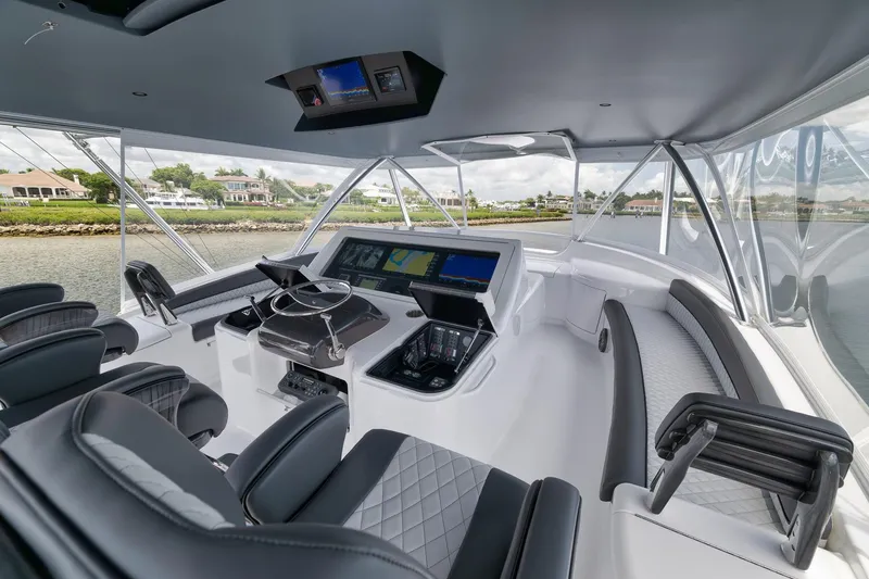 Slide: The Image of 2024 Viking 72 Convertible yacht cockpit with modern navigation equipment and luxurious seating. - 5