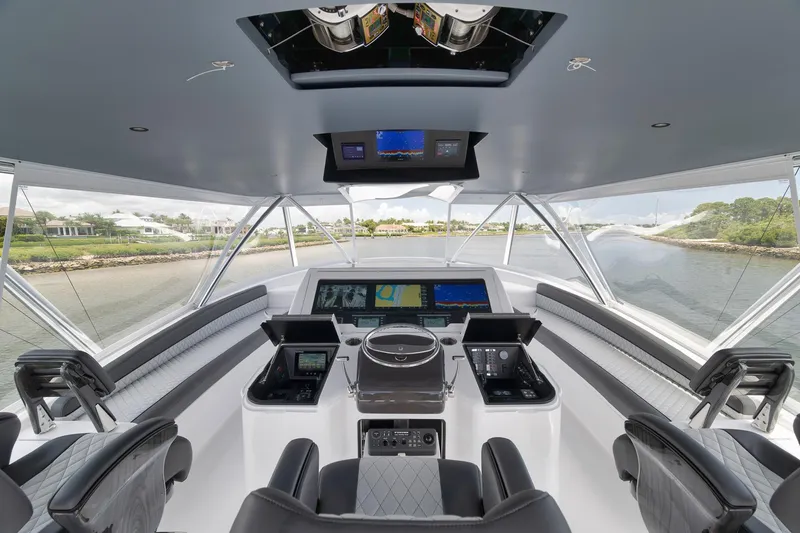Slide: The Image of 2024 Viking 72 Convertible yacht helm with advanced navigation systems and panoramic views. - 7