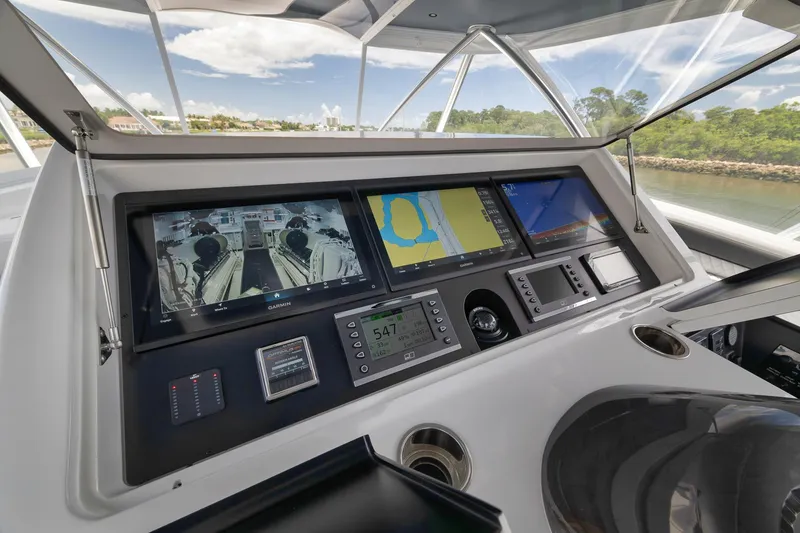 Slide: The Image of 2024 Viking 72 Convertible yacht dashboard with advanced navigation screens and controls. - 8