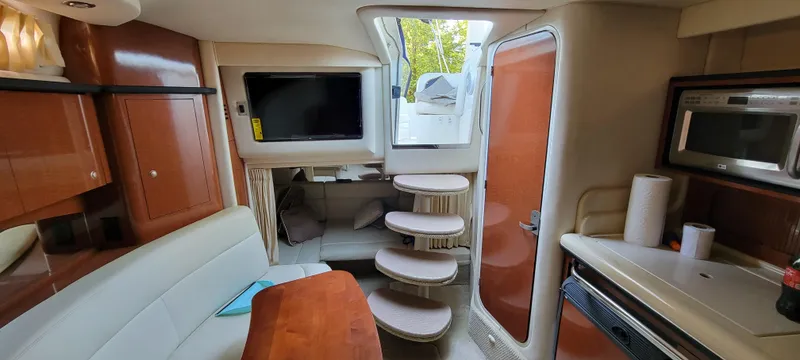 Slide: The Image of Interior of 2005 Sea Ray 320 Sundancer with TV, stairs, and kitchenette. - 15