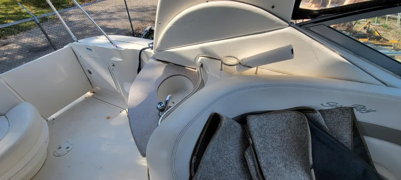 Slide: The Image of 2005 Sea Ray 320 Sundancer interior with seating and cup holder. - 22