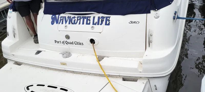 Slide: The Image of 2005 Sea Ray 320 Sundancer boat docked, named "Navigate Life," Port of Quad Cities. - 23