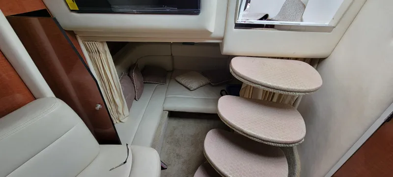 Slide: The Image of Interior of 2005 Sea Ray 320 Sundancer with curved steps and cozy seating area. - 25