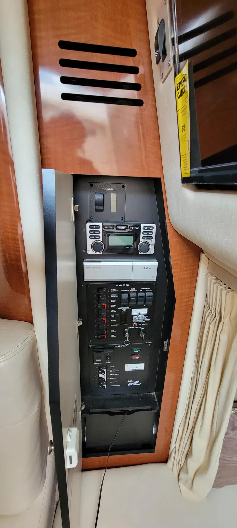Slide: The Image of Control panel inside 2005 Sea Ray 320 Sundancer boat, featuring electronic and audio systems. - 26