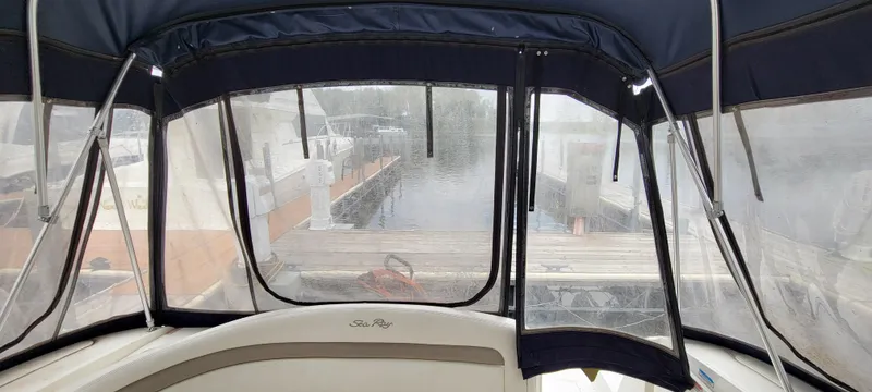 Slide: The Image of 2005 Sea Ray 320 Sundancer interior view with marina backdrop. - 27