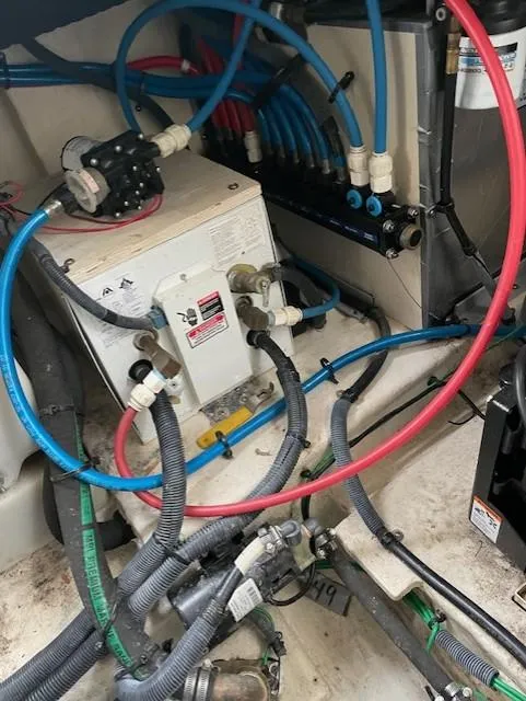 Slide: The Image of Engine compartment of a 2005 Sea Ray 320 Sundancer with visible wiring and components. - 35