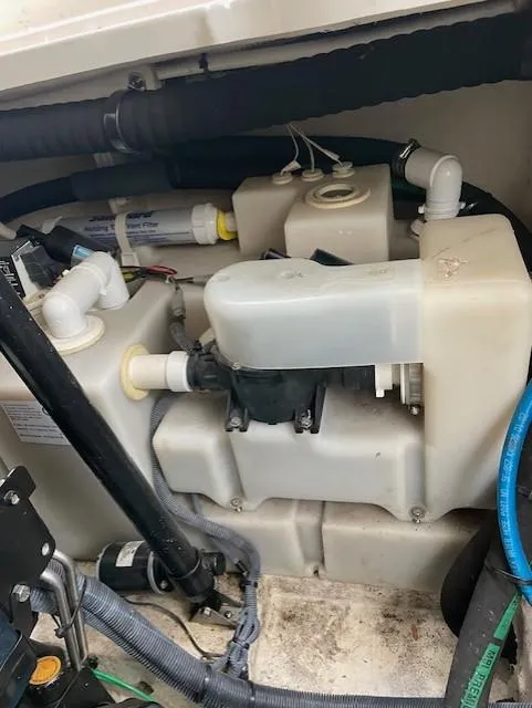 Slide: The Image of Engine compartment of a 2005 Sea Ray 320 Sundancer boat, showing mechanical components and wiring. - 36
