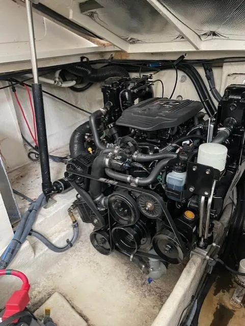 Slide: The Image of Engine compartment of a 2005 Sea Ray 320 Sundancer boat, showcasing mechanical components. - 38