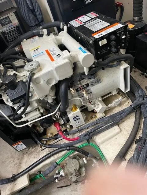 Slide: The Image of Engine compartment of a 2005 Sea Ray 320 Sundancer boat, showing mechanical components. - 42