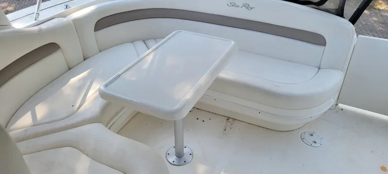 Slide: The Image of 2005 Sea Ray 320 Sundancer interior with white seating and table. - 6