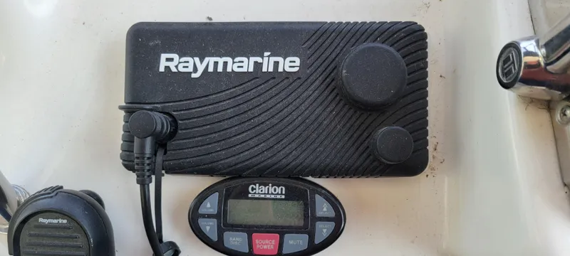 Slide: The Image of Raymarine and Clarion equipment on 2005 Sea Ray 320 Sundancer boat dashboard. - 8