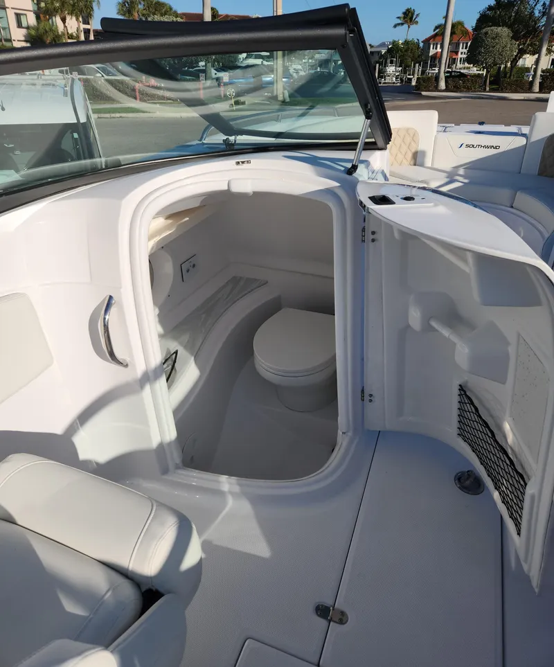 Slide: The Image of 2025 SouthWind 2600 SD boat interior with compact bathroom and seating area. - 12