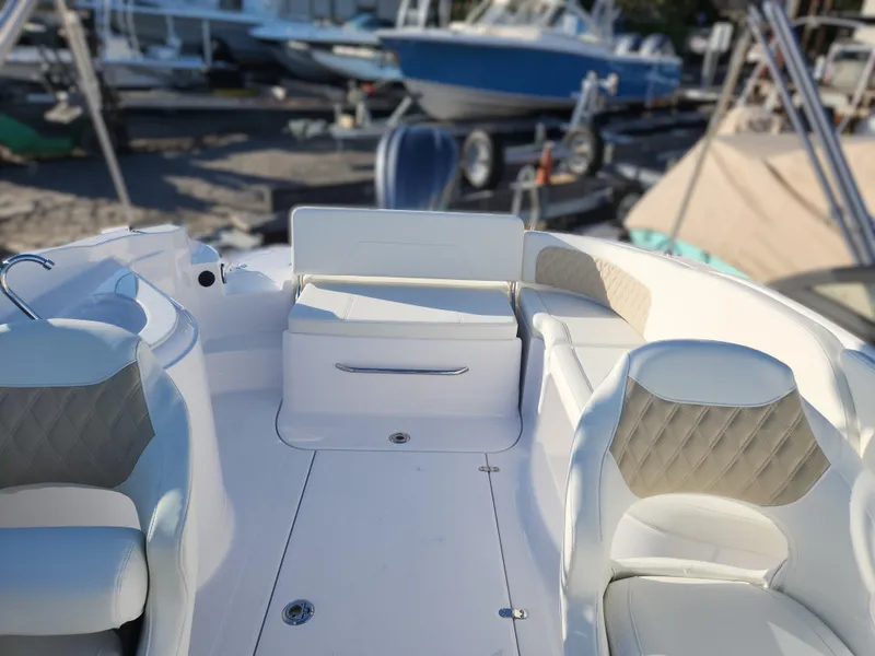 Slide: The Image of 2025 SouthWind 2600 SD boat interior with white seating and storage compartment. - 17