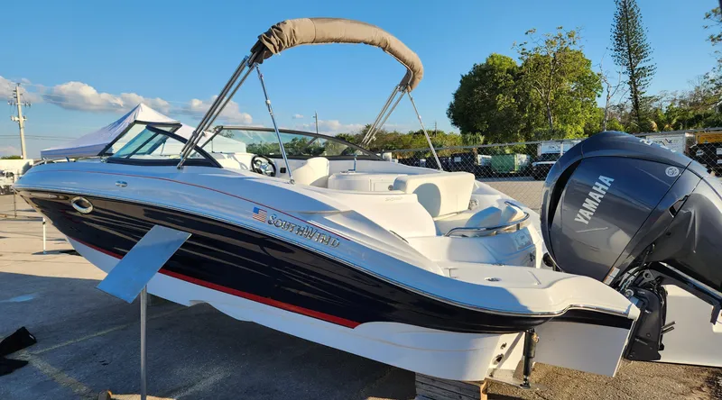 Slide: The Image of 2025 SouthWind 2600 SD boat with Yamaha engine, parked outdoors under clear sky. - 2