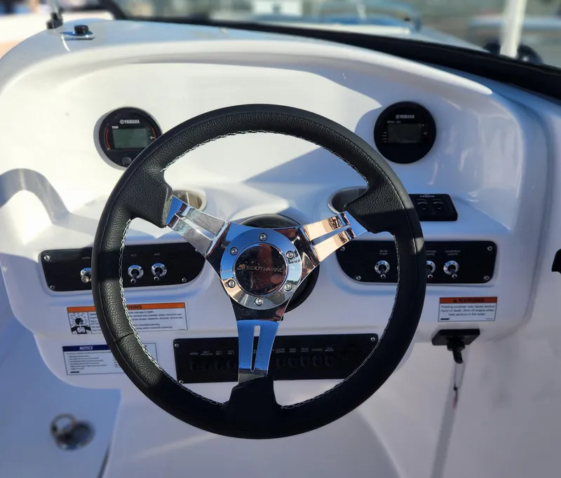 Slide: The Image of Steering wheel of 2025 SouthWind 2600 SD boat with dashboard controls. - 23