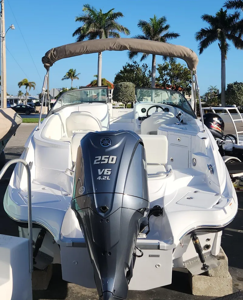 Slide: The Image of 2025 SouthWind 2600 SD boat with powerful 250 V6 engine, parked near palm trees. - 4