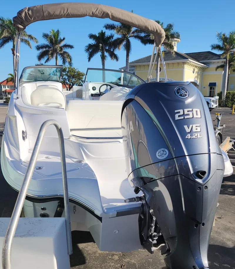 Slide: The Image of 2025 SouthWind 2600 SD boat with Yamaha 250 V6 engine, parked near palm trees. - 6