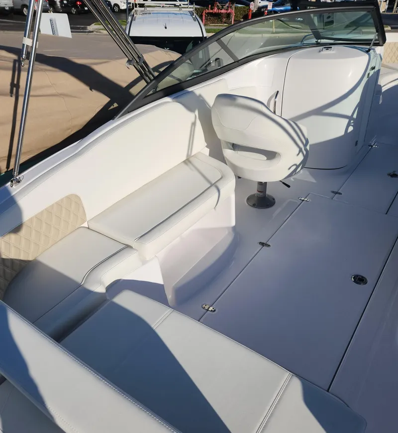 Slide: The Image of 2025 SouthWind 2600 SD boat interior with white seating and steering area. - 9