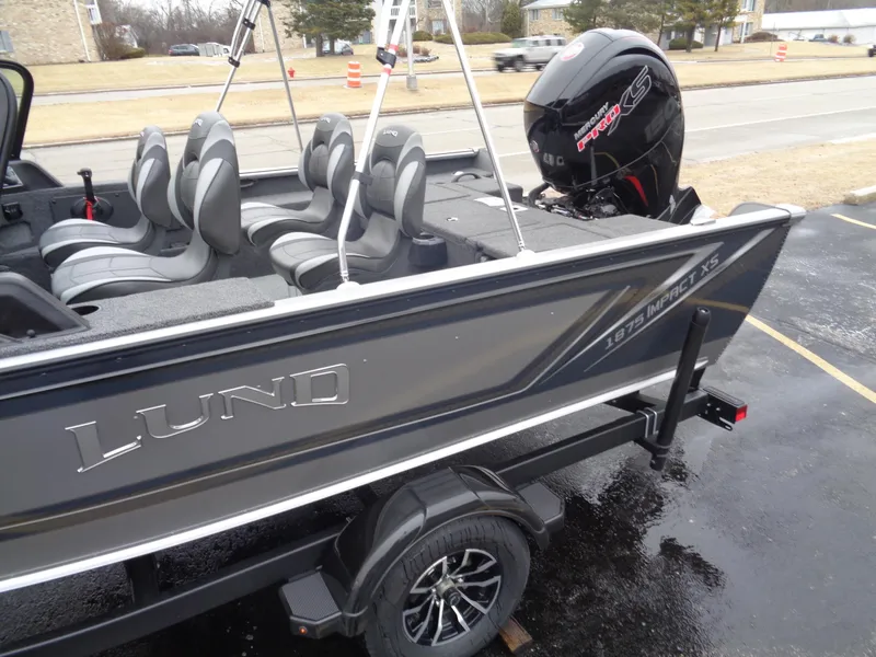 Slide: The Image of 2025 Lund 1875 Impact XS Sport boat with sleek design and modern seating. - 4