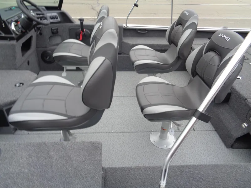 Slide: The Image of 2025 Lund 1875 Impact XS Sport boat interior with four gray cushioned seats. - 8