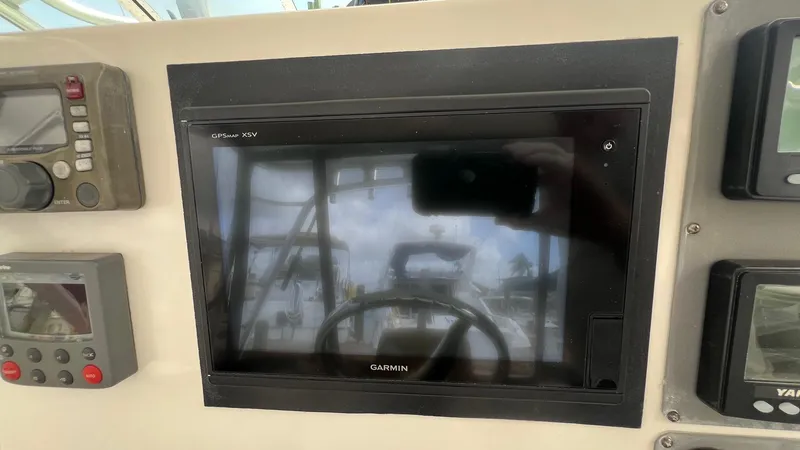 Slide: The Image of Control panel of a 2006 Rampage 30 Offshore boat with Garmin display. - 16