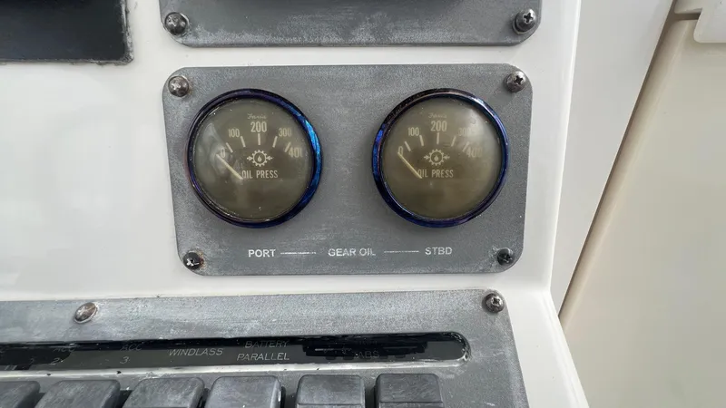 Slide: The Image of Oil pressure gauges on a 2006 Rampage 30 Offshore boat dashboard. - 21