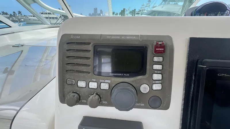 Slide: The Image of Control panel of a 2006 Rampage 30 Offshore boat with radio and navigation equipment. - 24