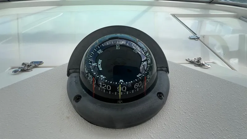 Slide: The Image of Compass on 2006 Rampage 30 Offshore boat dashboard, displaying navigation directions. - 26