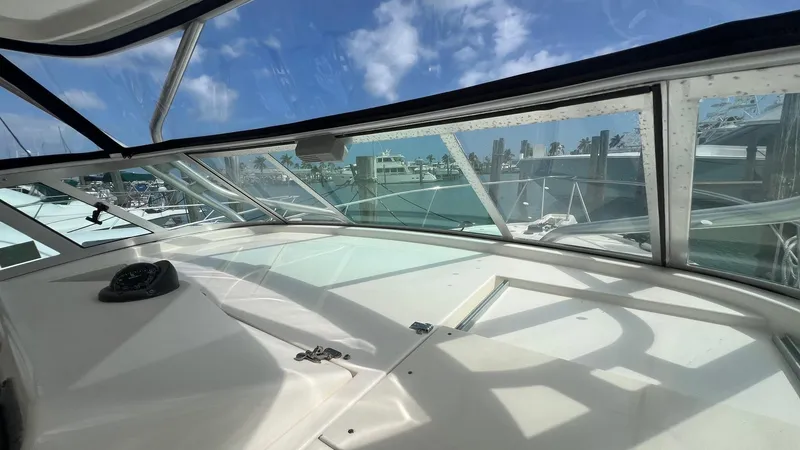 Slide: The Image of 2006 Rampage 30 Offshore boat interior with clear windows and marina view. - 27