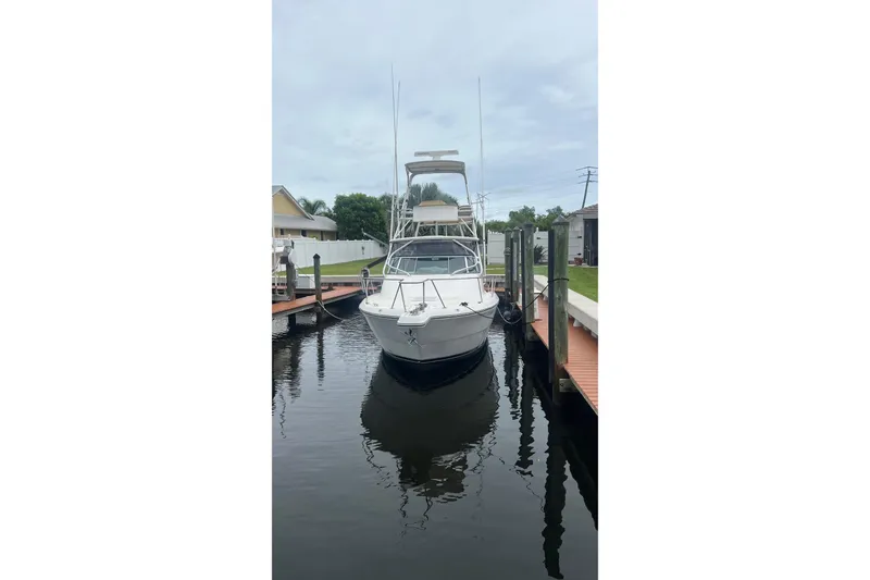 Slide: The Image of 2006 Rampage 30 Offshore boat docked in a calm marina setting. - 3