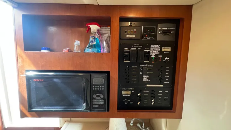 Slide: The Image of 2006 Rampage 30 Offshore interior with microwave and control panel. - 33