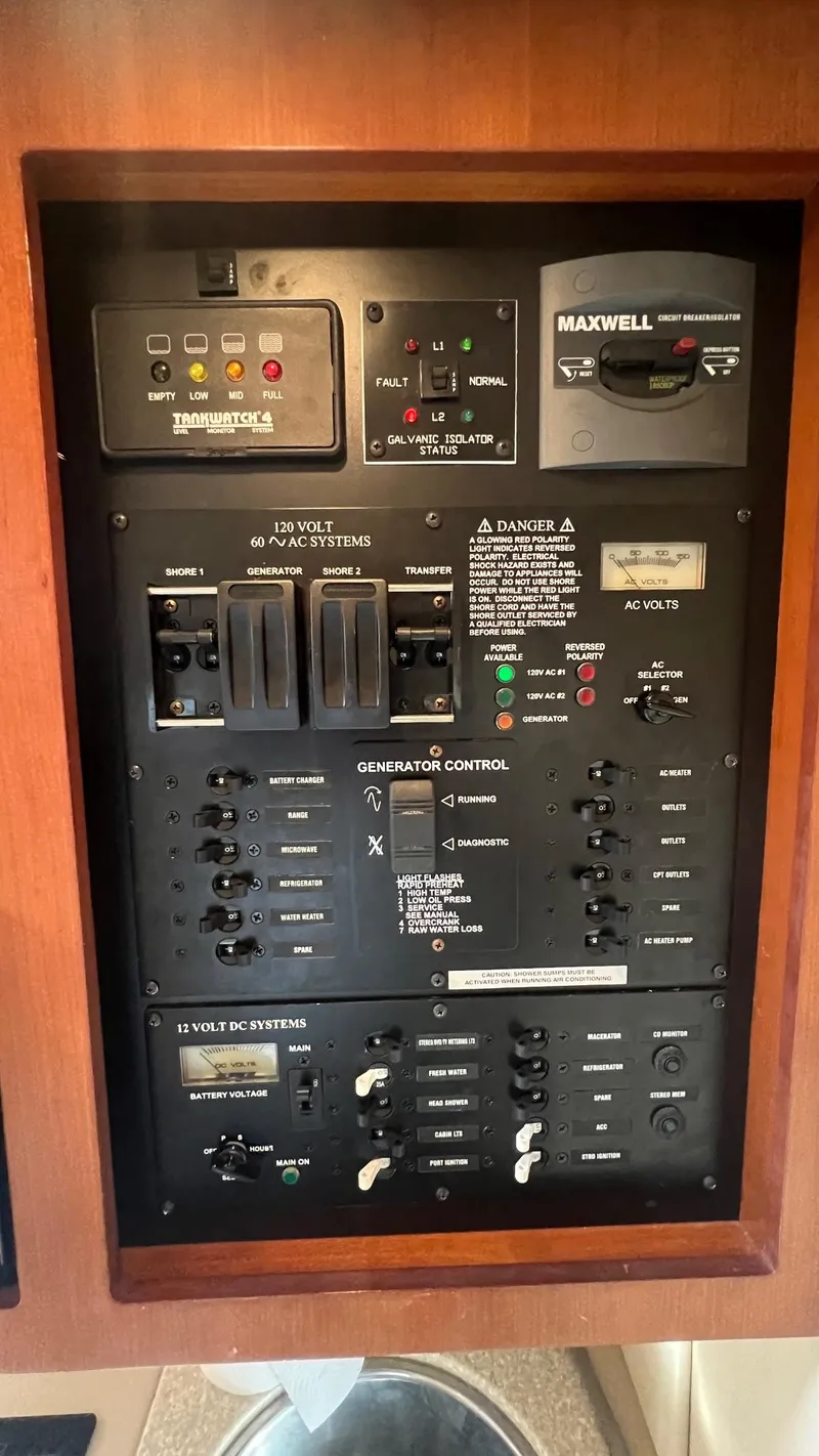 Slide: The Image of 2006 Rampage 30 Offshore control panel with switches and gauges in wooden frame. - 34