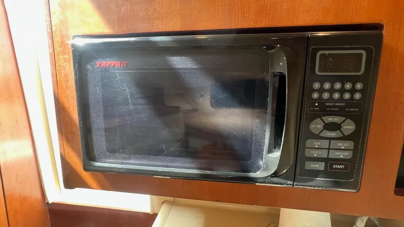 Slide: The Image of Microwave in 2006 Rampage 30 Offshore boat kitchen, wooden cabinetry. - 35